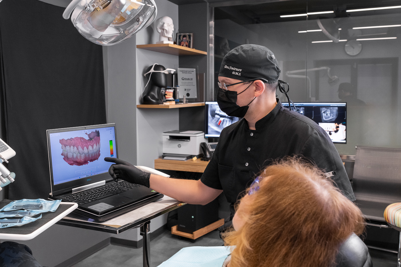 Dentist at Studio 32 planning implant treatment on a digital 3D scan